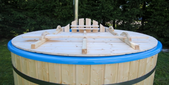 barrel hot tub with fire heater in the garden