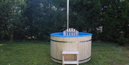 Fiberglass wooden hot tub with wood burning heater in garden